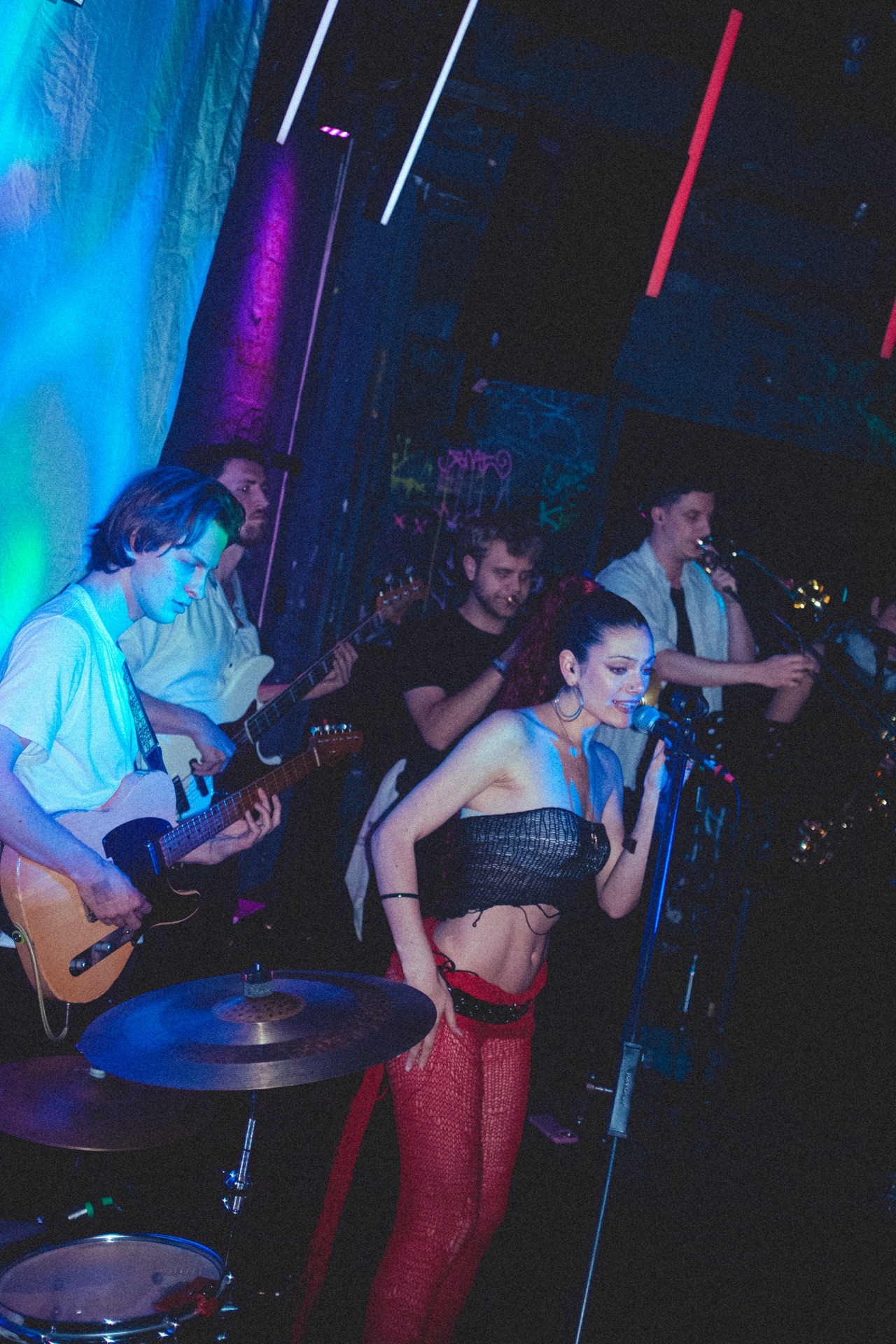 Loulia seated in red club light