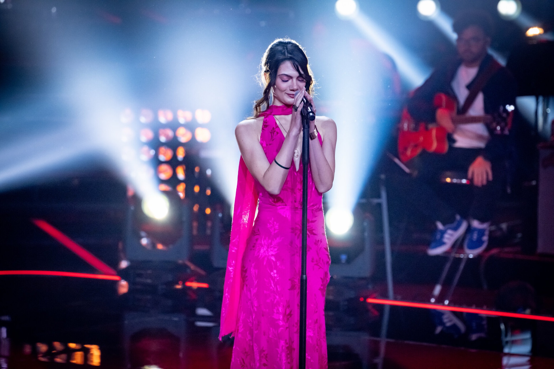Loulia on stage in blue and magenta light